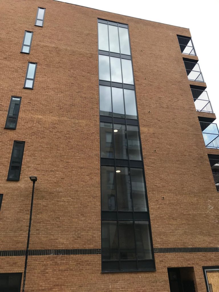 Installation of aluminium curtain wall windows and push-out openers on a commercial building in Enfield.