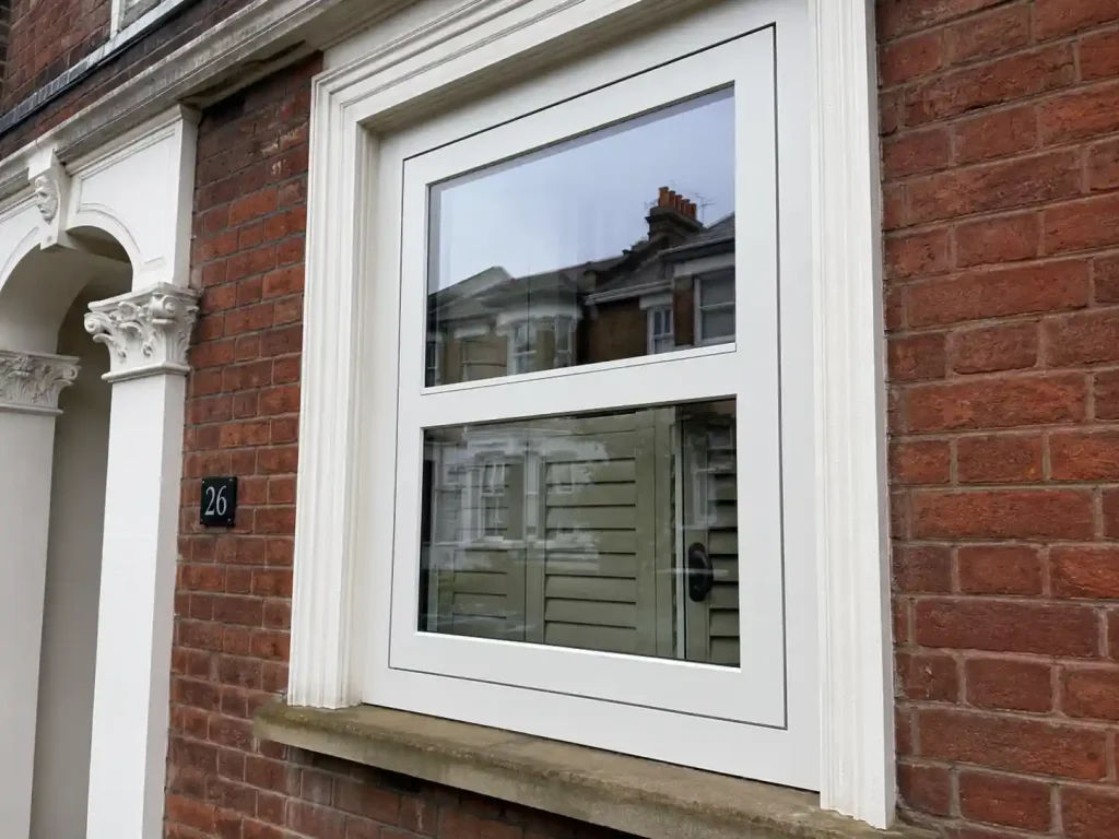 uPVC flush sash window installed on the facade of a Victorian red brick terraced property in North London